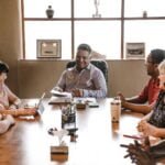 people sitting around wooden table