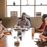 people sitting around wooden table