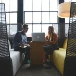 coworkers looking at laptop