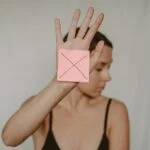 woman with paper with cross sign