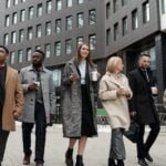 coworkers taking a coffee break and walking