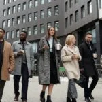 coworkers taking a coffee break and walking